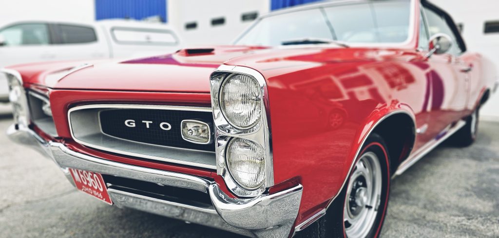 Classic red Pontiac GTO freshly detailed and parked outside Retro Detailing in Bowling Green, OH